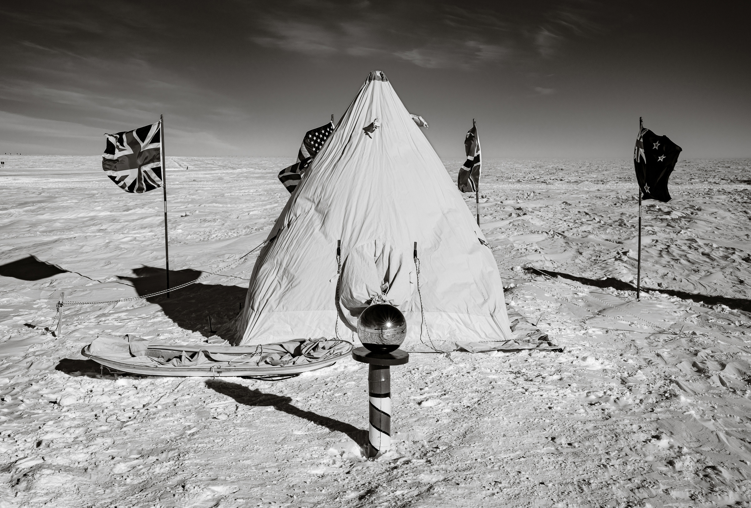 Click to Enlarge Ceremonial South Pole with the flags of the original signatories of the Antarctic Treaty.