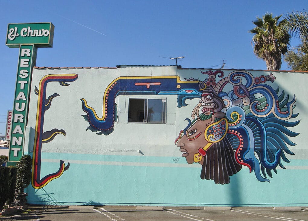 Mural of Mayan head on exterior wall of restaurant.