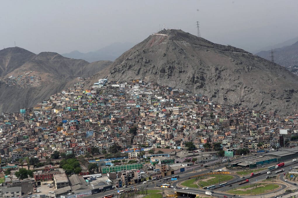 Gray cinder-like hills with sprawling informal settlement nestled between them.
