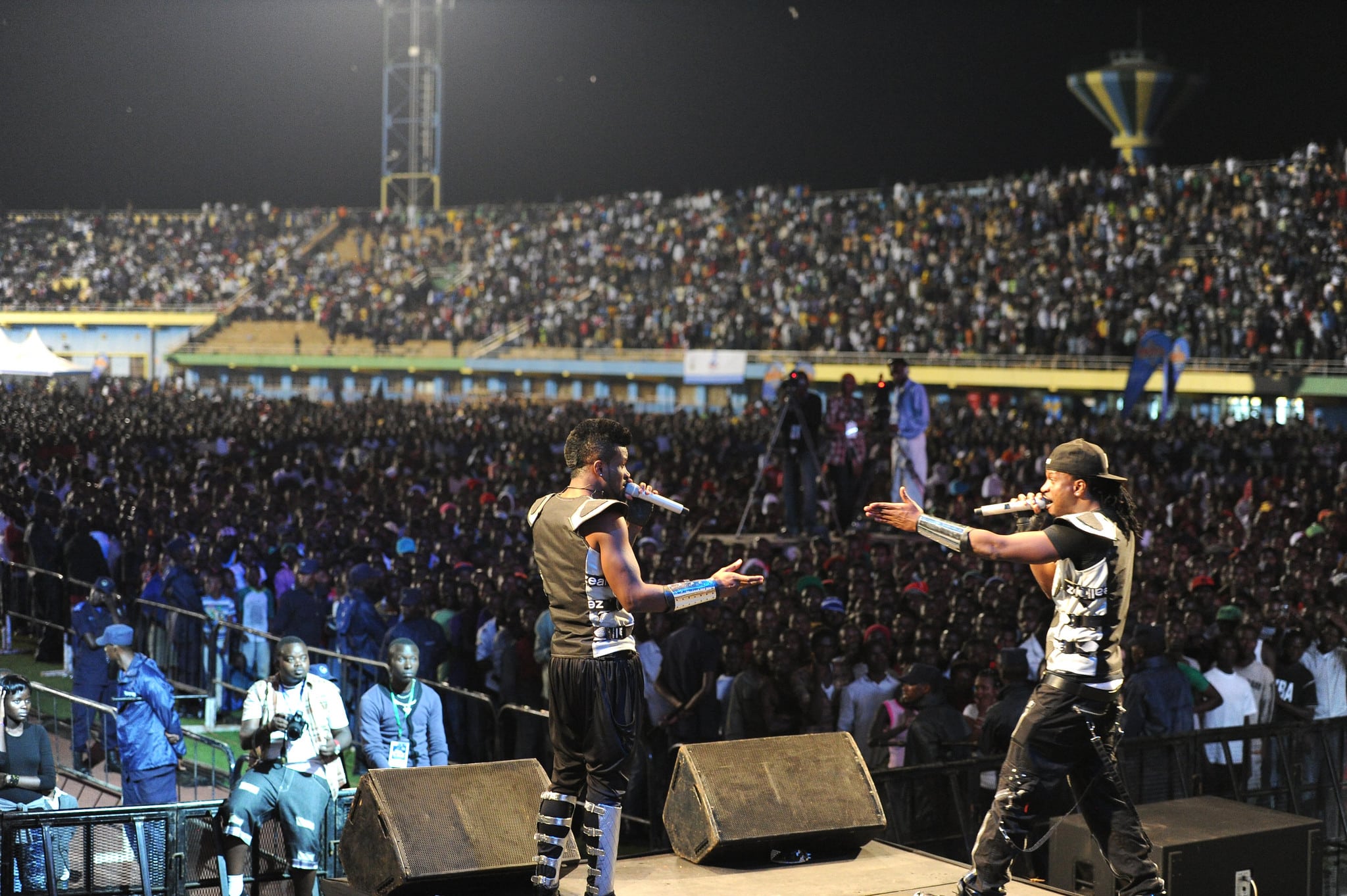 Click to Enlarge Rap duo performing onstage in packed stadium.