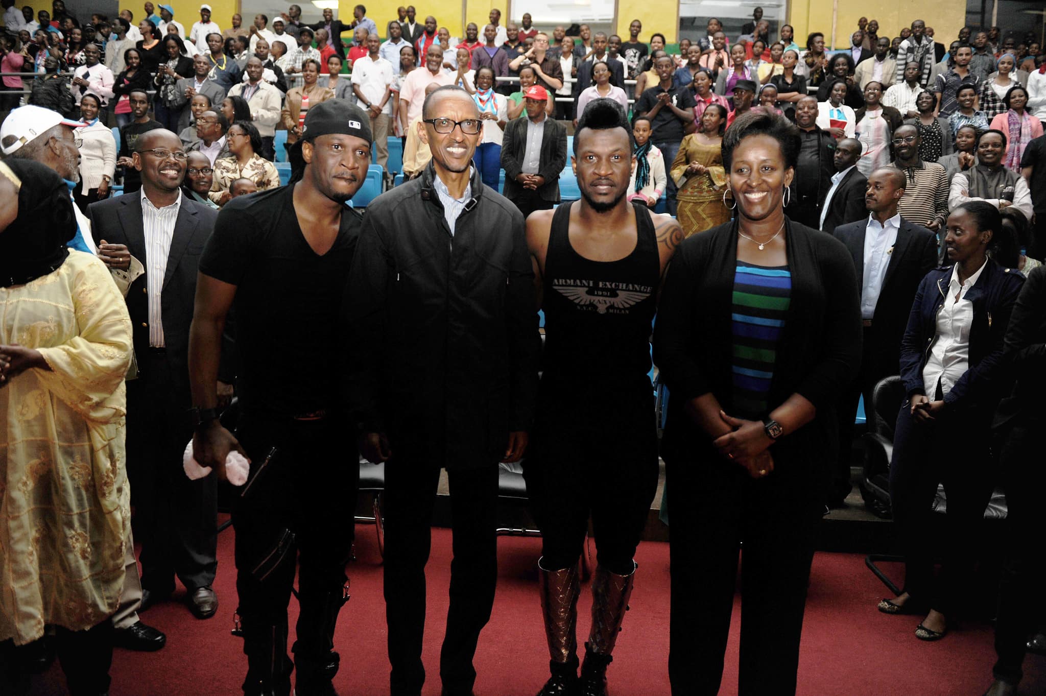 Click to Enlarge Four Black celebrities on a red carpet, surrounded by all-Black crowd.