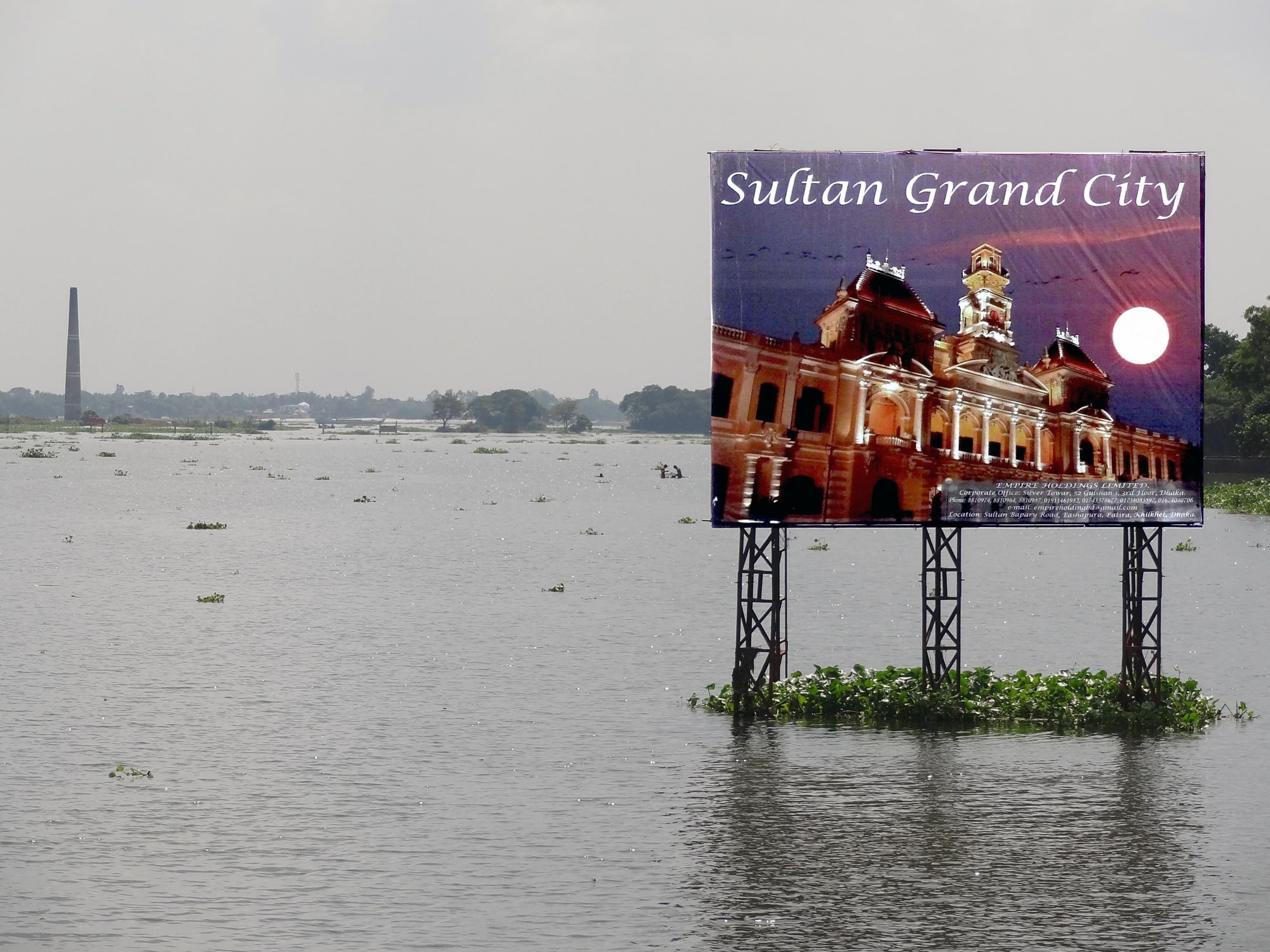 Click to Enlarge Color photograph of billboard showing large neoclassical building labeled