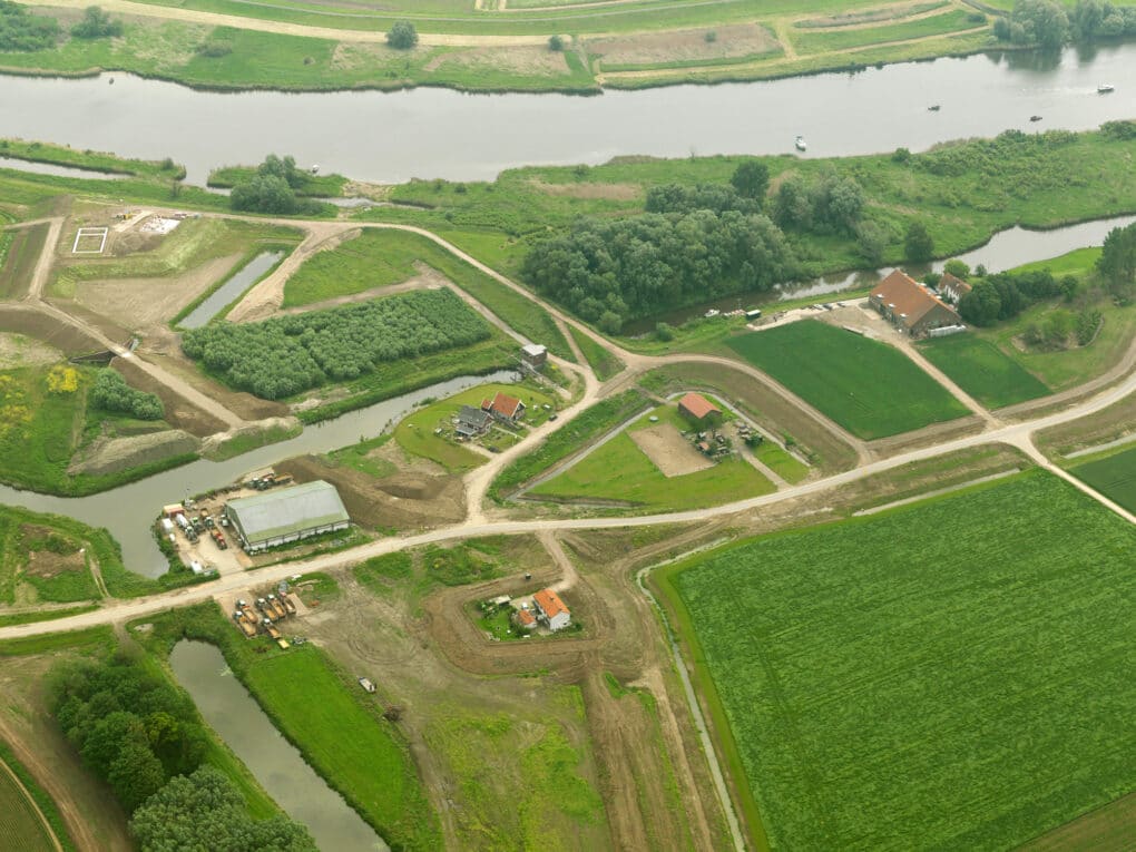 Aerial view of landscape interventions such as canals and earth walls in an agricultural landscape along a river