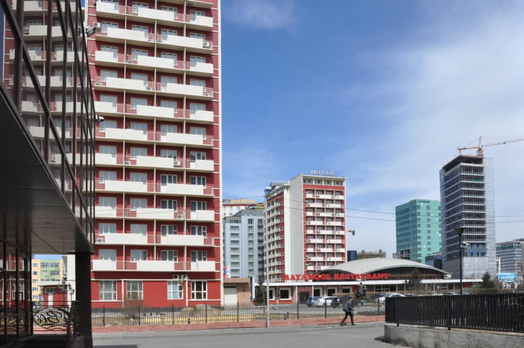 Color photograph of red and white apartment blocks.