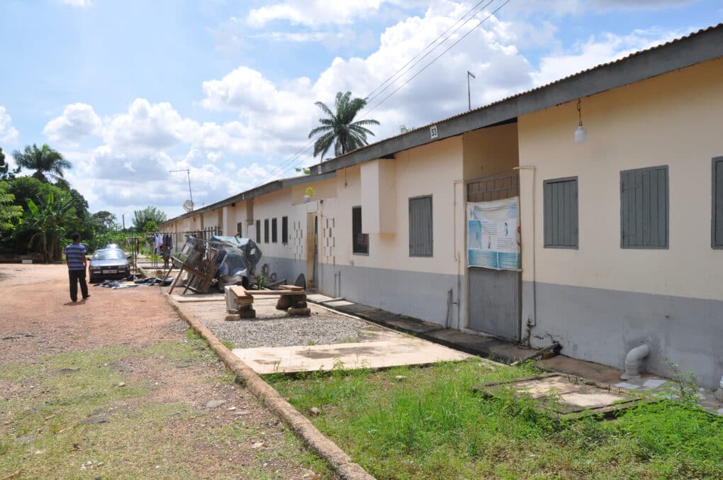 Color photograph of one-story concrete housing block.