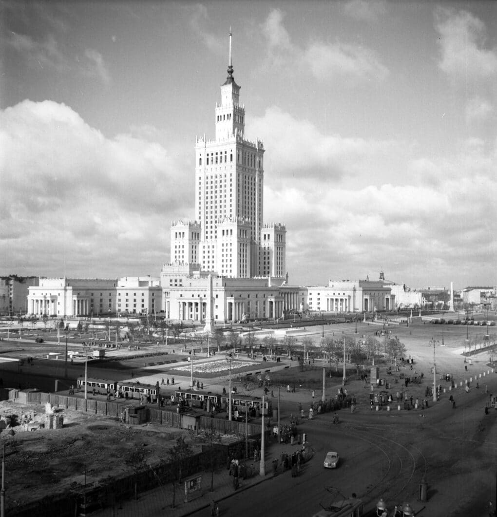 Black and white photograph of large Socialist-classicist tower with flanking pavilions.