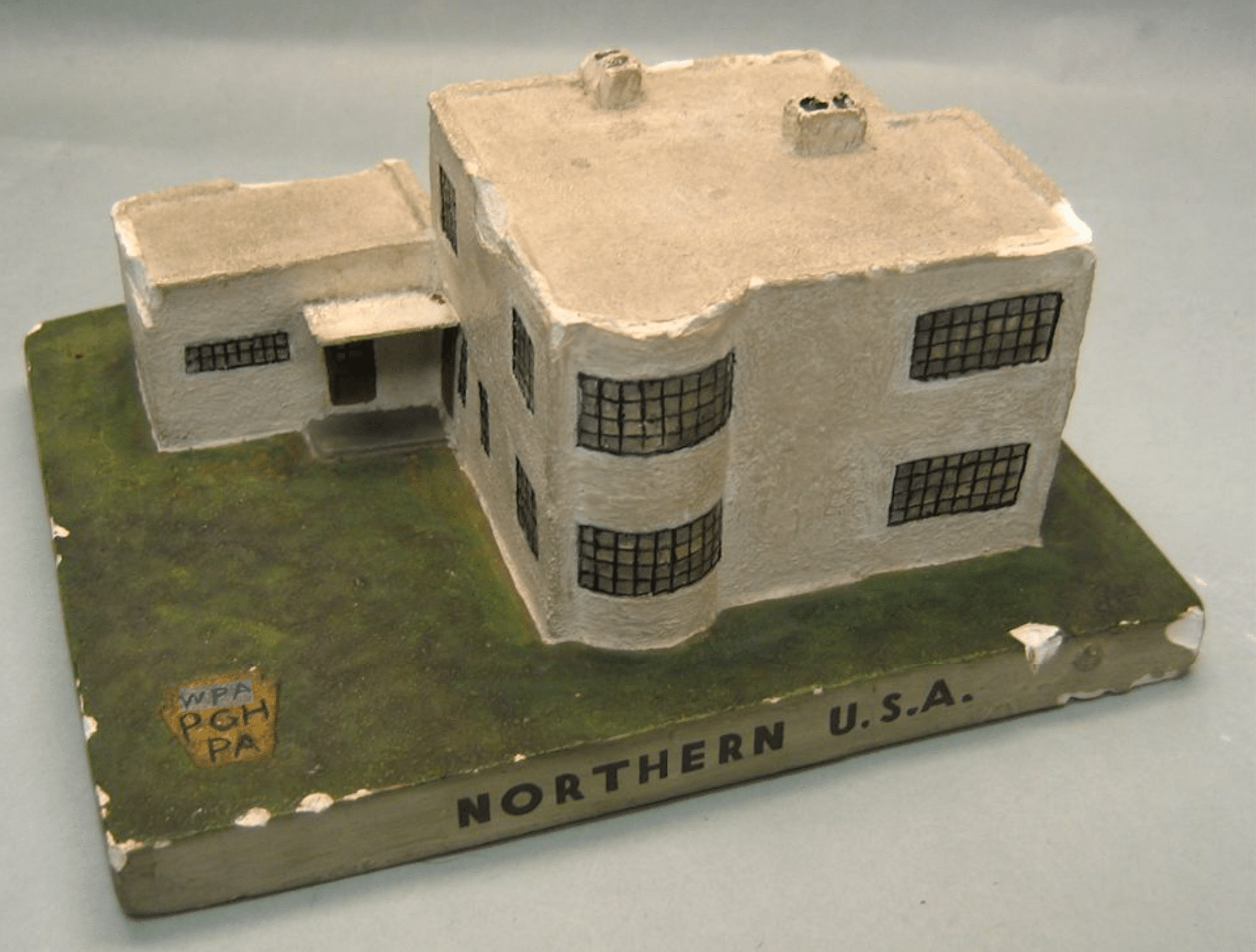 Click to Enlarge A plaster model of a modernist structure on a base that says