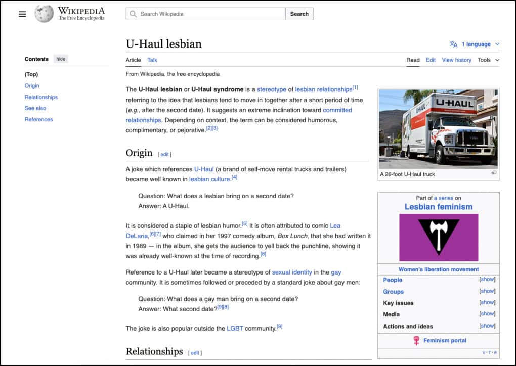 Screenshot of Wikipedia page shows color photograph of U-Haul truck, and graphic of labyris double-headed axe, in white in a black downward-pointing triangle against a purple background.