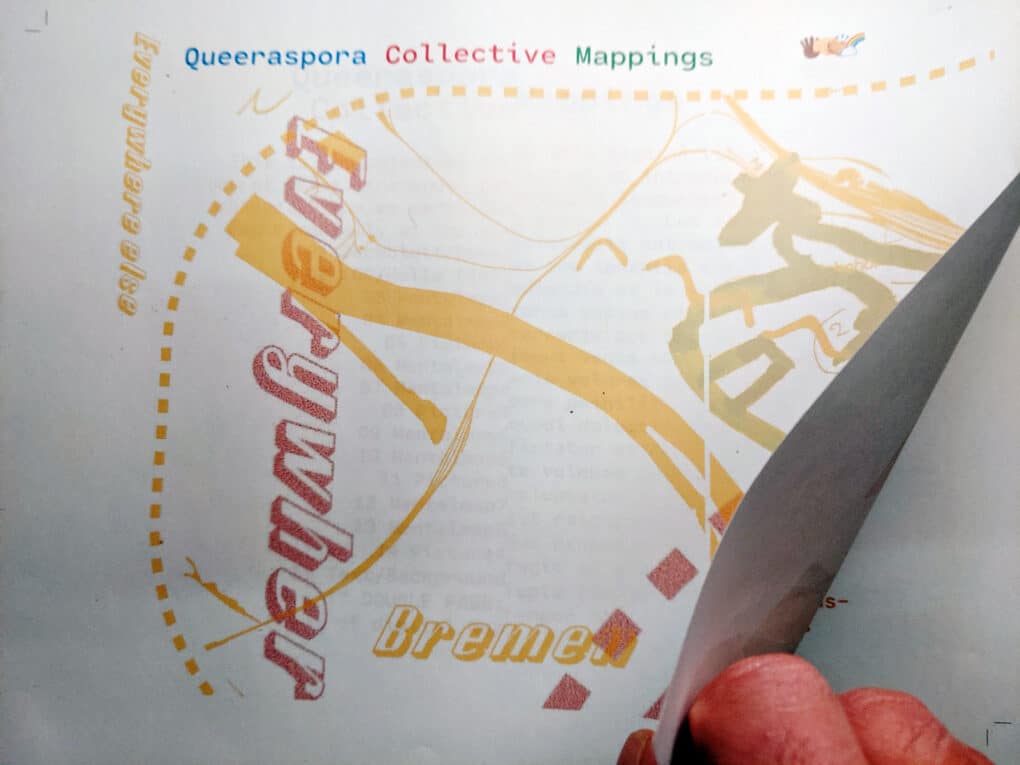 A cover page of a horizontal brochure with a section of a map on it. One hand is opening the brochure.
