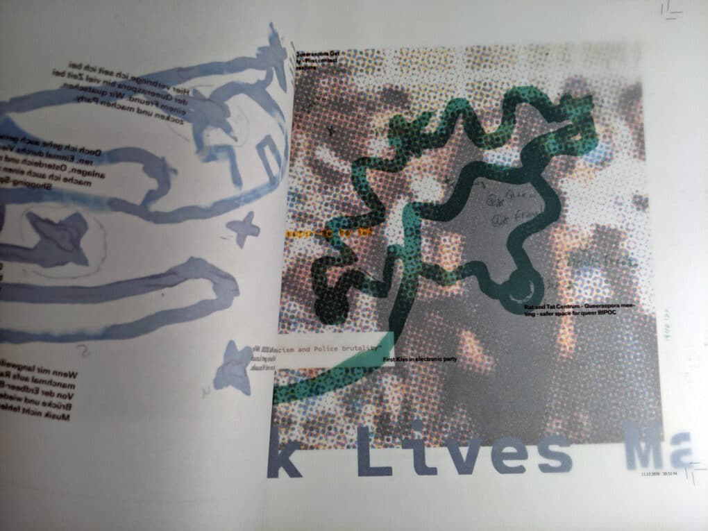 Pages of an open booklet with hand-drawn maps. A picture of a demonstration is visible through semi-transparent paper.