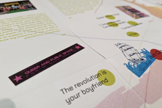 Closeup of a portion of a double-sided, multi-folded printed map including, colored dots connected by lines and captioned with quotes and other text blocks, plus some photographs. Visible text reads: "The revolution is your boyfriend"