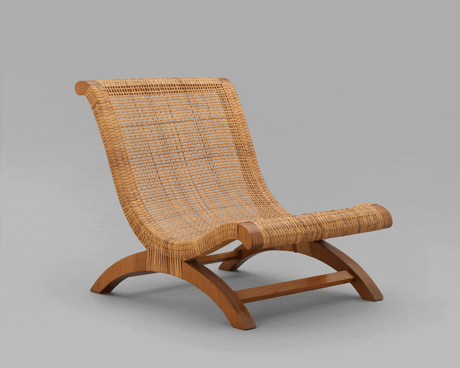 Click to Enlarge Clara Porset, Butaque, 1957; laminated wood and woven wicker.