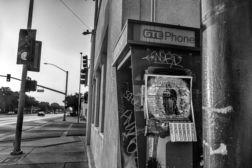 Advertisement for psychic and witchcraft services, on a telephone booth in downtown Santa Maria, 2024. 
