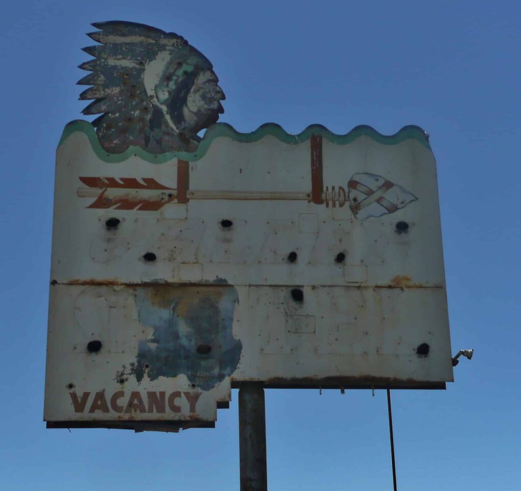 Faded old Valley Motel sign in Santa Maria, California, with Native American caricature.
