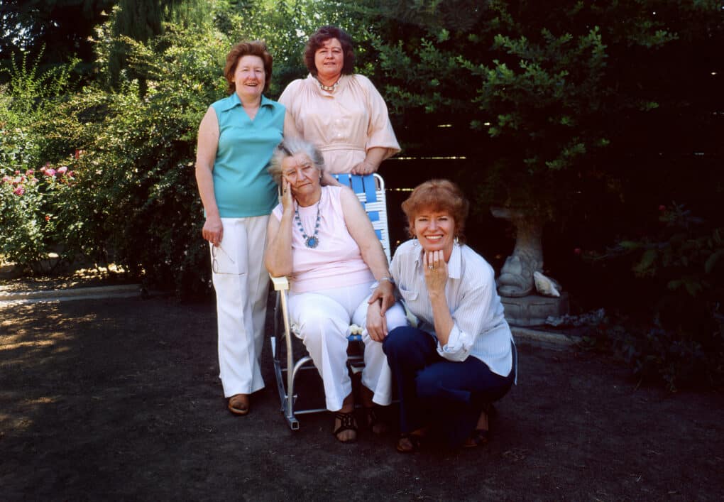 Family portrait, in color, of Florence Leona Thompson with her daughters Norma Rydlewski (in front), Katherine McIntosh, and Ruby Sprague, at Norma's house in Modesto, California, June 1979.