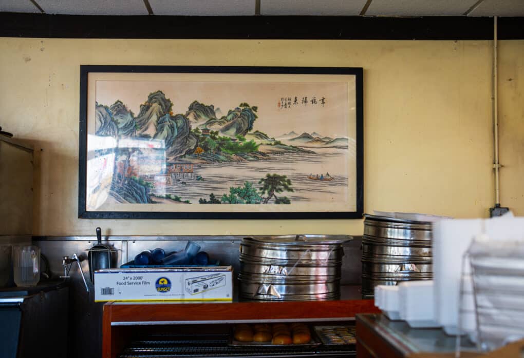 Apparently a scene behind the counter at Won Kok. There's a water pitcher, an ice scoop, cellophane, Styrofoam to-go containers, and round metal steaming baskets.