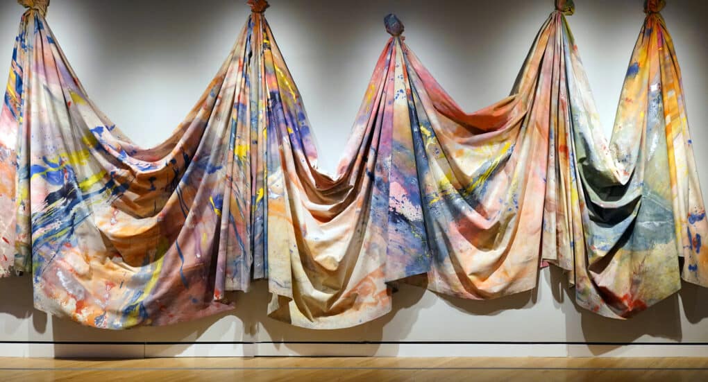 Color photograph of large draped polychromed canvas.