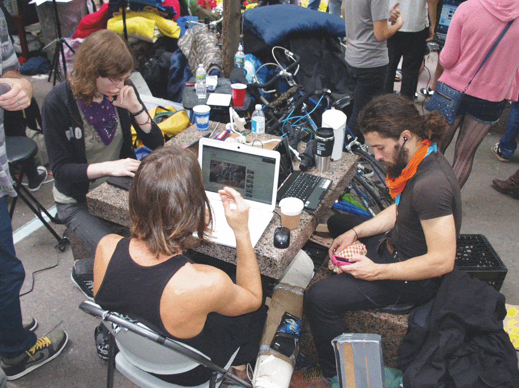 Activists sitting at a table during Occupy Wall Street, Day Nine, September 25, 2011.