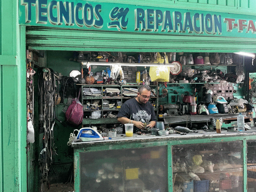 Joel Martínez Soto repairing a juicer in his family's repair shop on Edificio Carranza in Articulo 123 Street, Mexico City, June 2020.