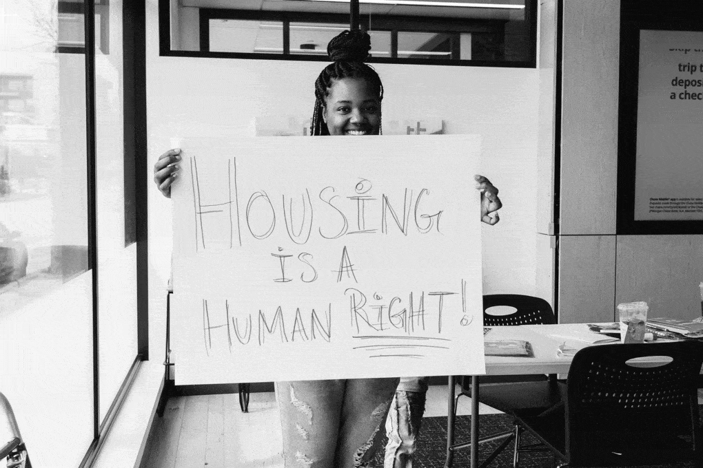 Nikki of Moms4Housing holds a sign with the group’s central principle: “Housing is a Human Right!” Photograph by Clara Perez.