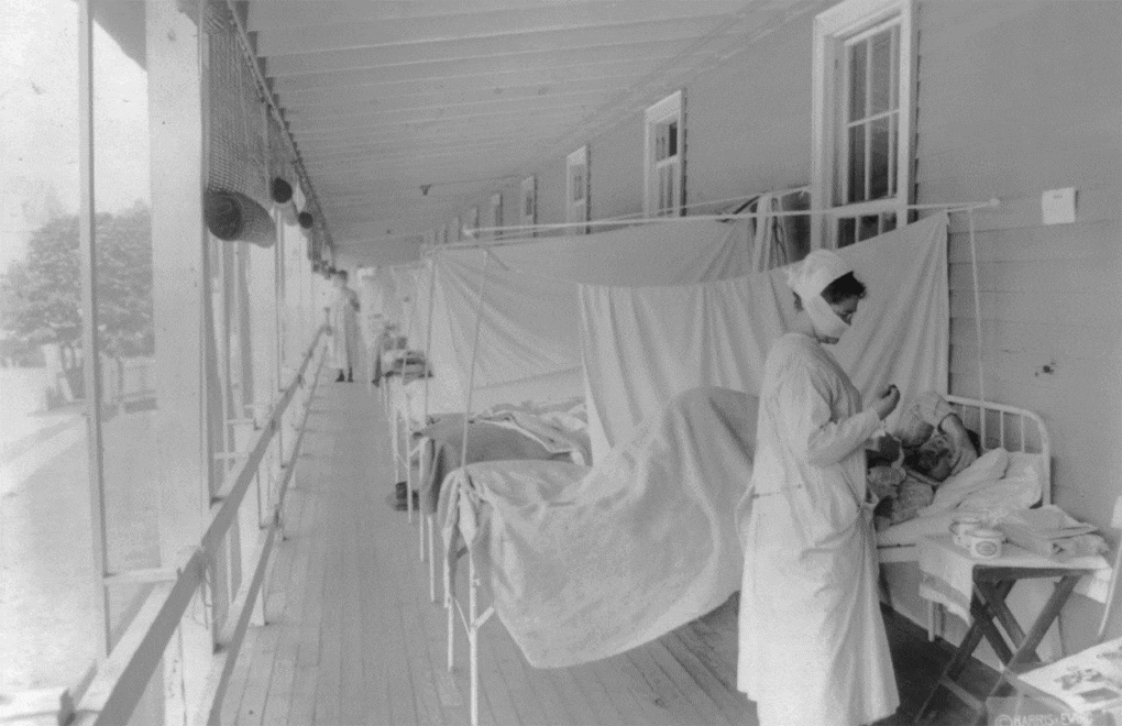 Influenza ward, Walter Reed Hospital, Washington D.C., nurse taking patient's pulse. ,ca. 1918.