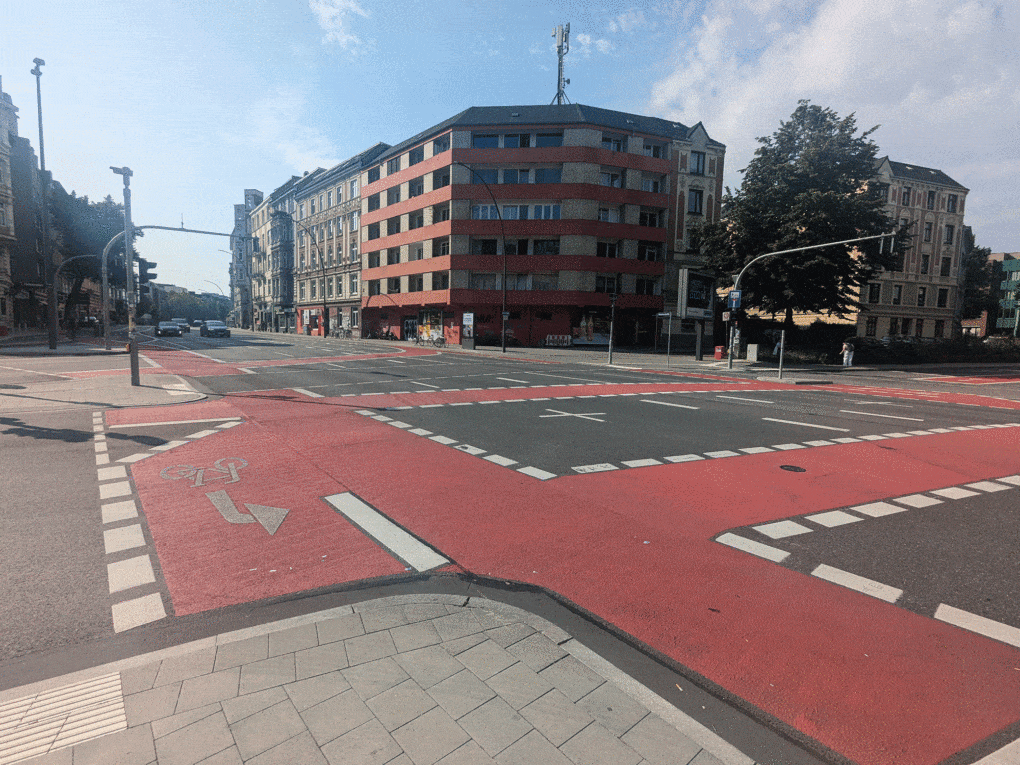 Intersection, painted with arrows, bars, dashed and solid lines and some red colored areas, near the author's apartment in Hamburg, Germany. 