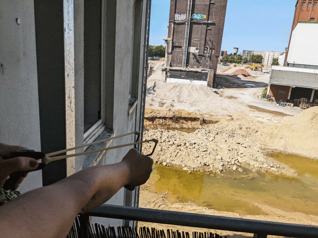 A neighbor shoots seeds at the abandoned construction site. 