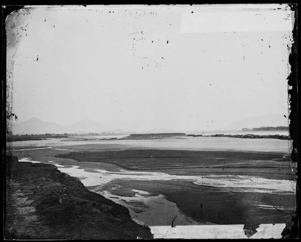 Black and white photo of river flooding.