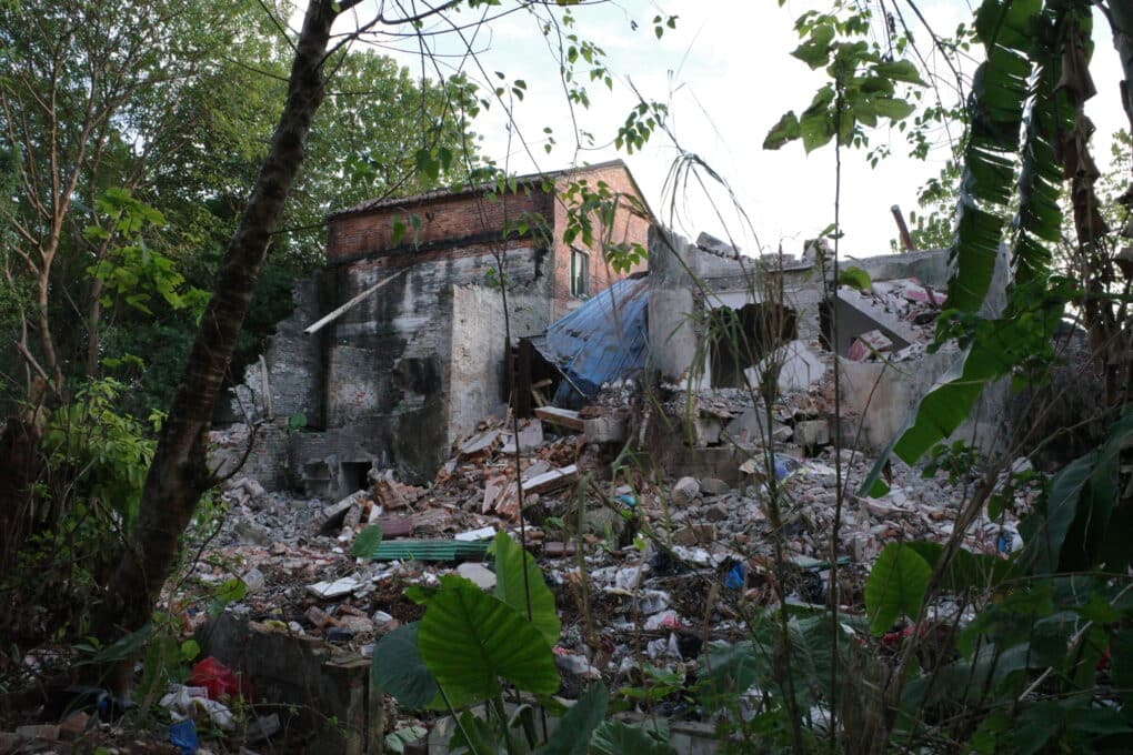 Crumbling brick buildings and large quantity of debris.