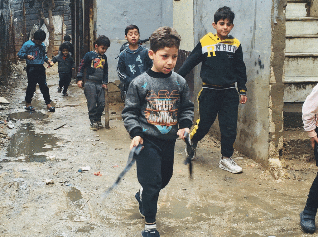 Syrian children at play in a junk yard in Burj Al-Barajneh Palestinian camp, 2020. Photo by Roula El Khoury and Paola Ardizzola, from their chapter "Syrian Children’s Imagination and Play Areas Beyond the Physical Reality of Urban Spaces in Beirut," in The Urban Refugee.