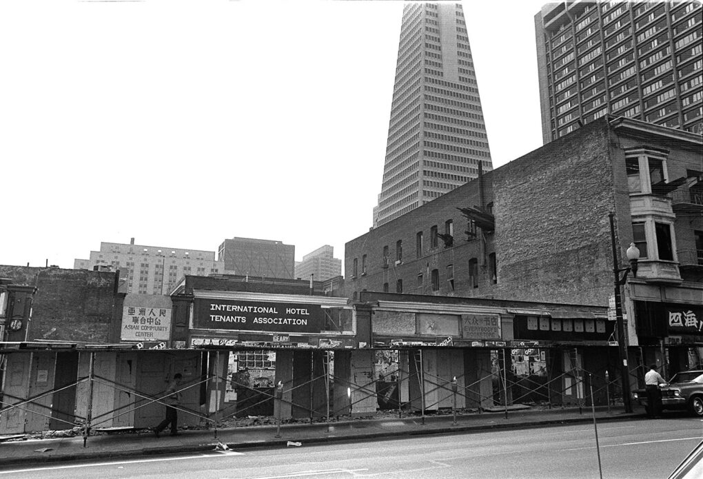 An empty block with only the building facade still standing, and sign that says "International Hotel Tenants Association."