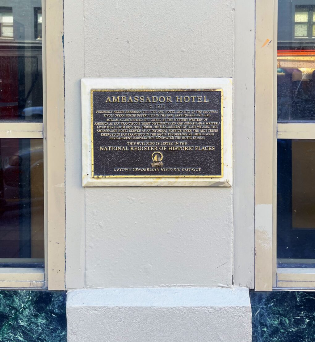 Historic building plaque on Ambassador facade. 