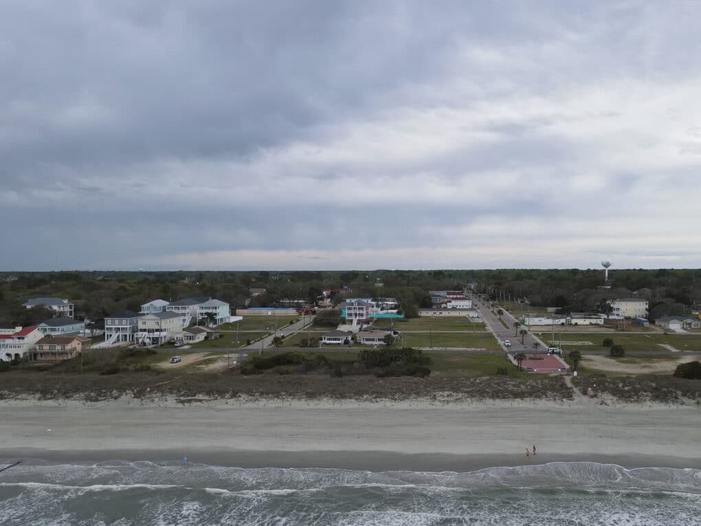 Color photograph with aerial view of small beach community.