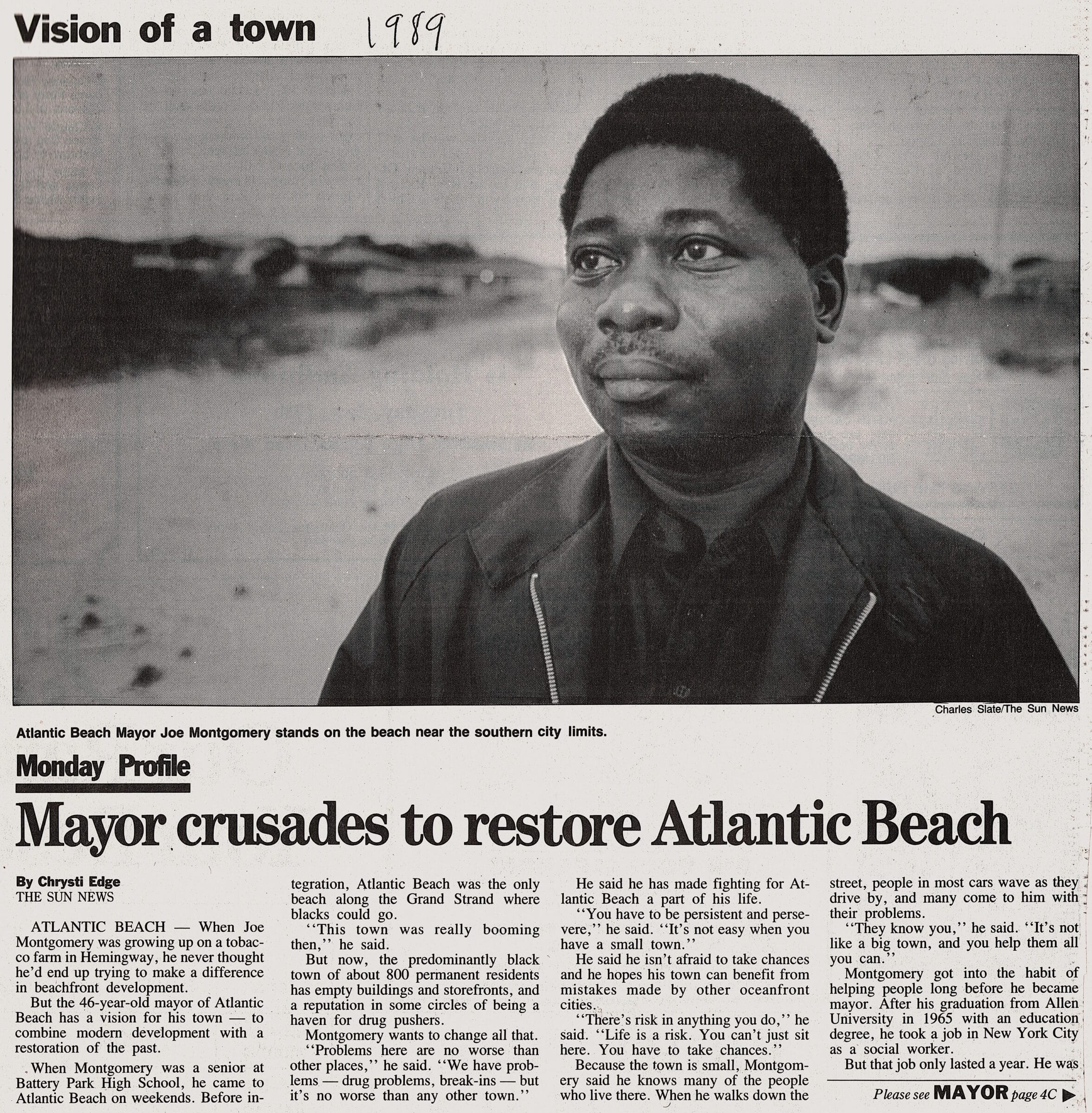 Click to Enlarge Black-and-white photo of a newspaper clipping with a large photograph of a young Black man and the headline