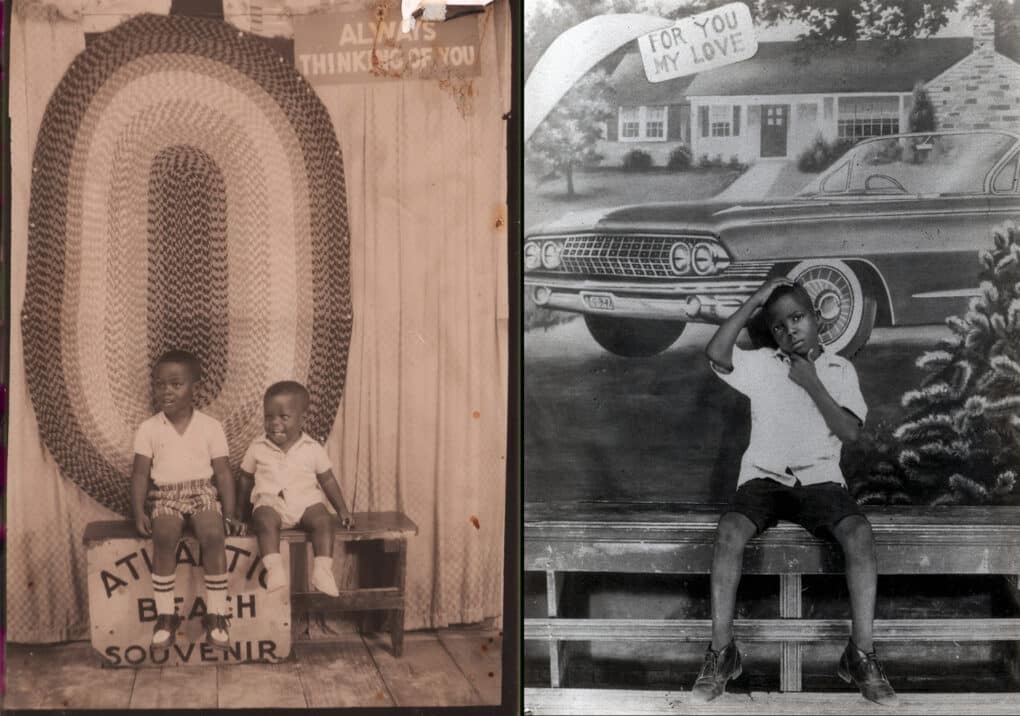Two black-and-white photos: LEFT: Two little Black boys, seated on a wooden bench painted with the words ATLANTIC BEACH SOUVENIR. On the wall behind them hangs a large oval rag rug, and another sign reading ALWAYS THINKING OF YOU; RIGHT: A small Black boy, one hand on the top of his head and the other on his chin, seated on a wooden bench before a backdrop painting of a car and white house, with a sign reading FOR YOU MY LOVE.