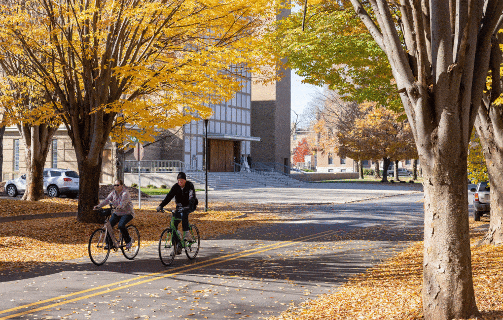 Cyclists riding by the First Christian Church, formerly Tabernacle Church of Christ. Design by Eliel Saarinen in 1942, the building was the first commission by the Miller family in Columbus, Indiana.