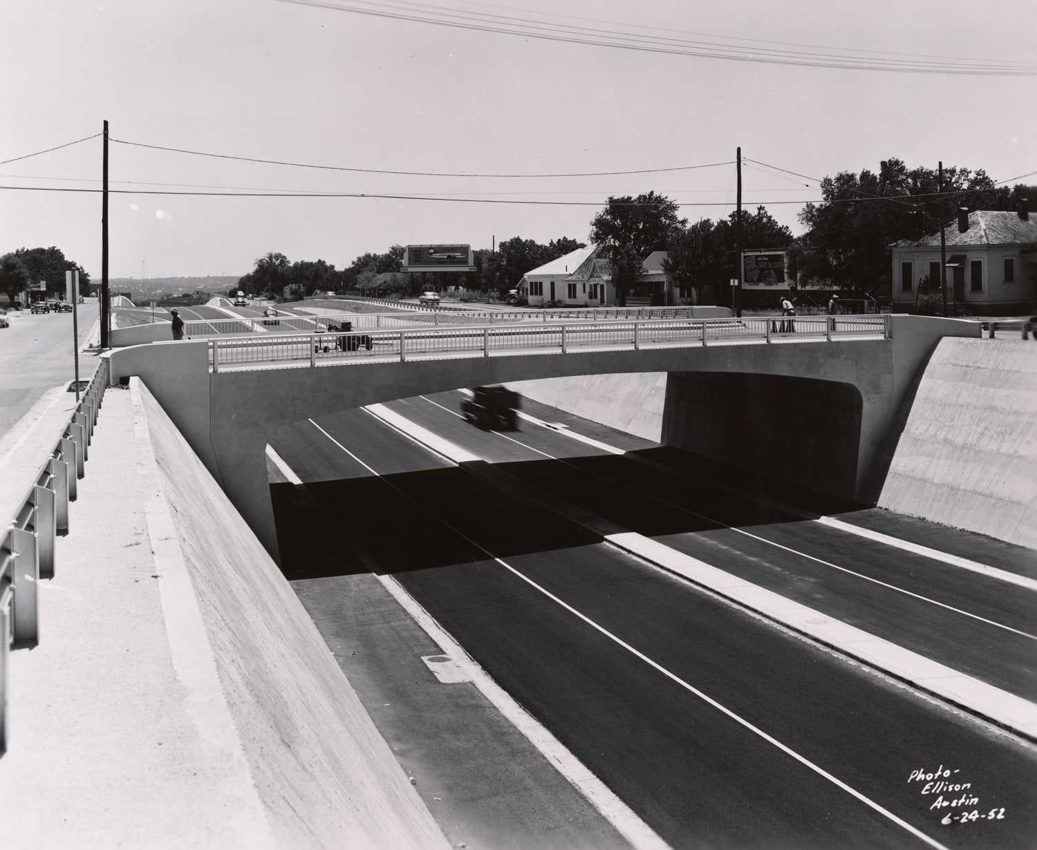 Click to Enlarge Black-and-white photograph of freeway and overpass.