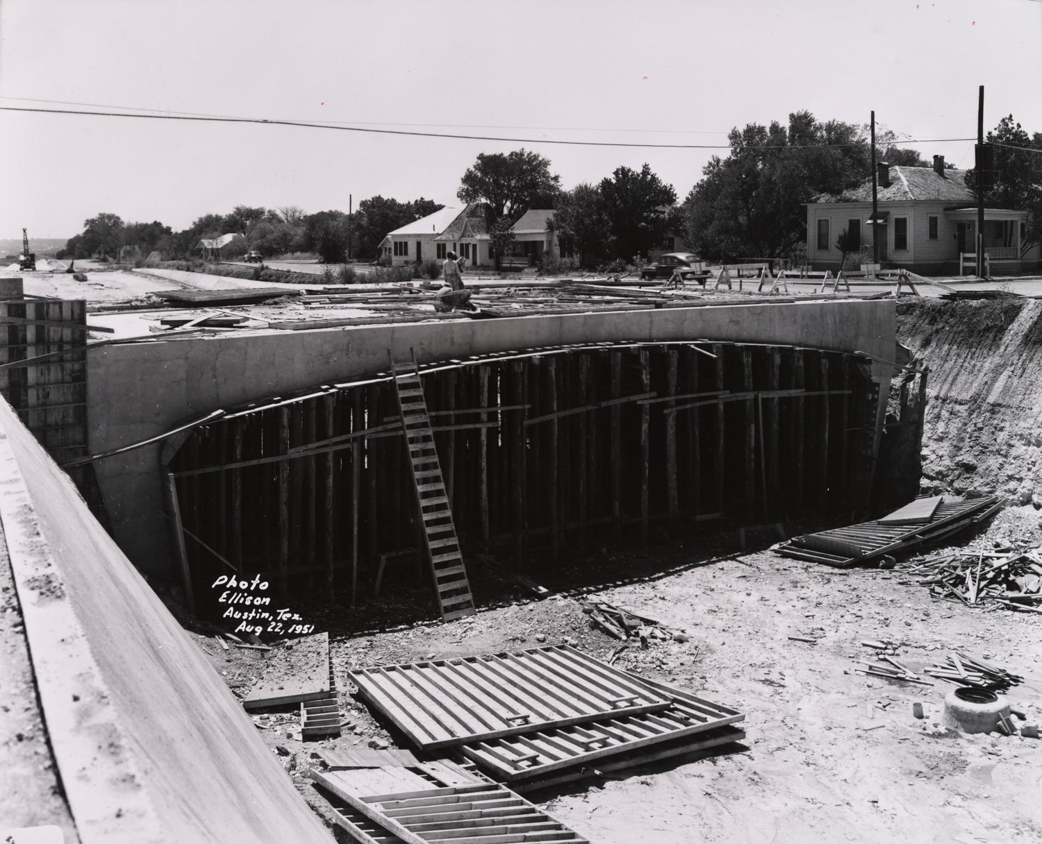 Click to Enlarge Black-and-white photograph of freeway roadbed and overpass under construction.