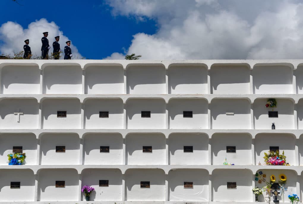 Color photograph of a four-story stucco mausoleum building.