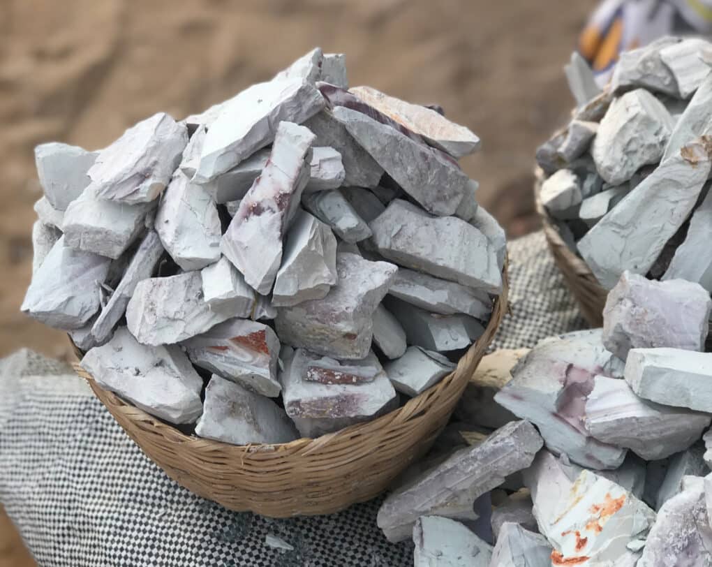 Color photo of chunks of white clay in a basket.