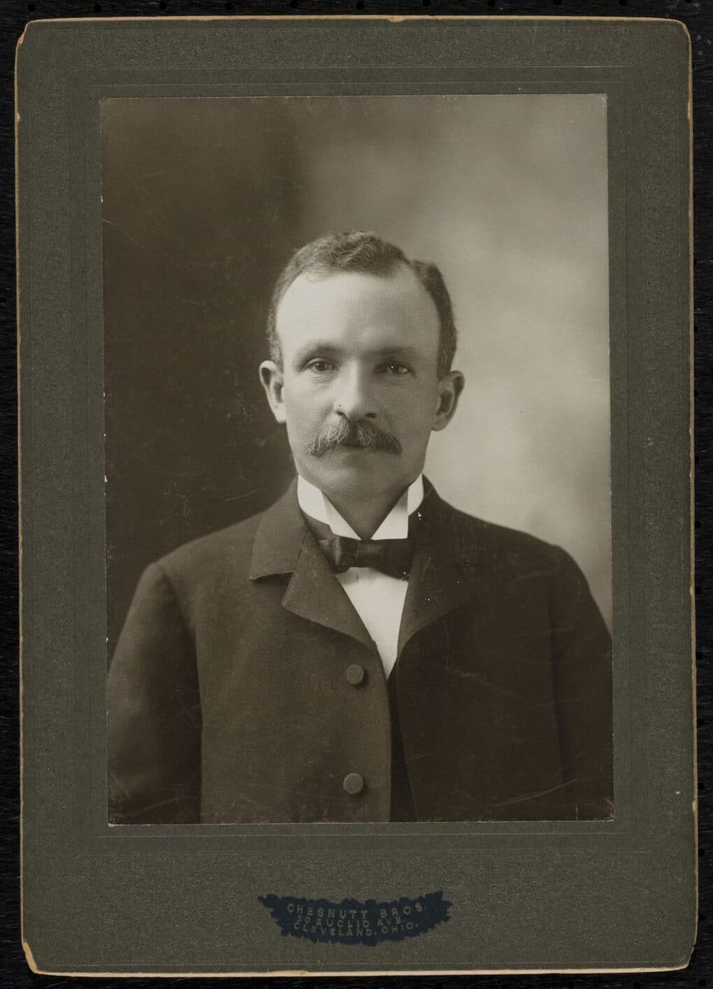 Black-and-white photograph of white-appearing man in a suit and tie.