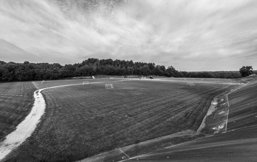 Black and white photograph of an expansive plain dotted with soccer goals.