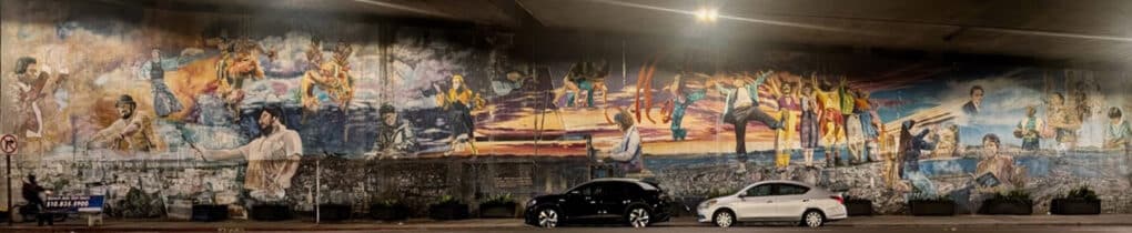 Color photograph of large mural under freeway overpass