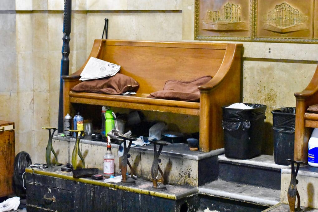 Color photograph of a cluttered, old-fashioned shoeshine stand.