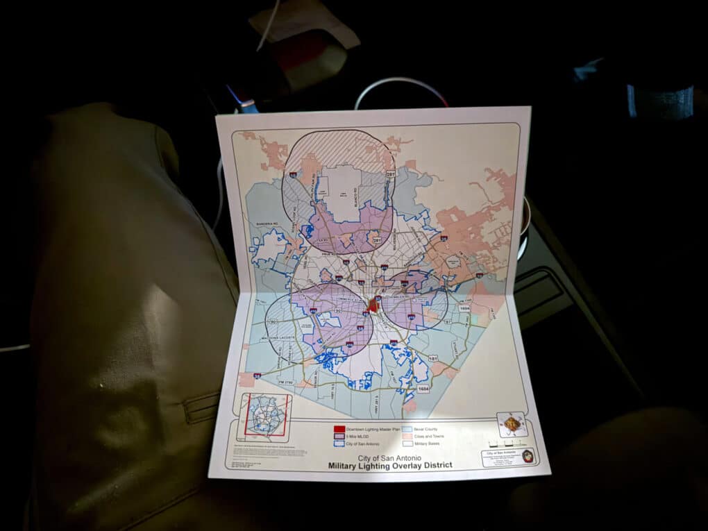 Color photograph of an unfolded map booklet against a dark background.